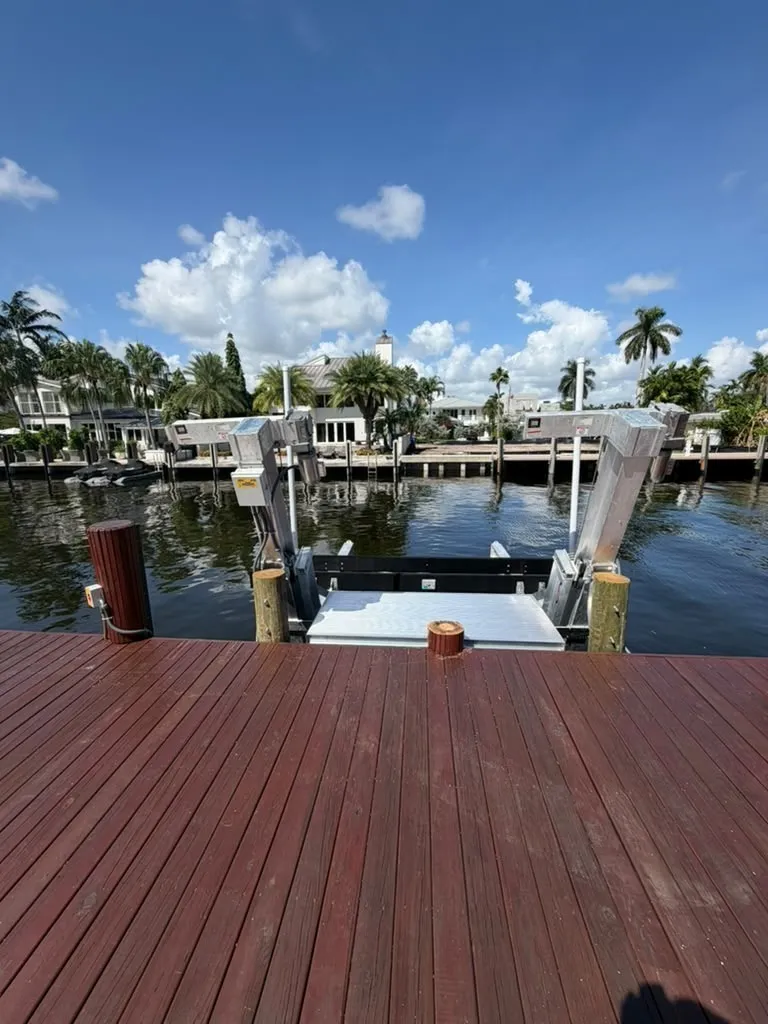 Beam-to-beam aluminum boarding platform between boat lift beams on a Fort Lauderdale canal