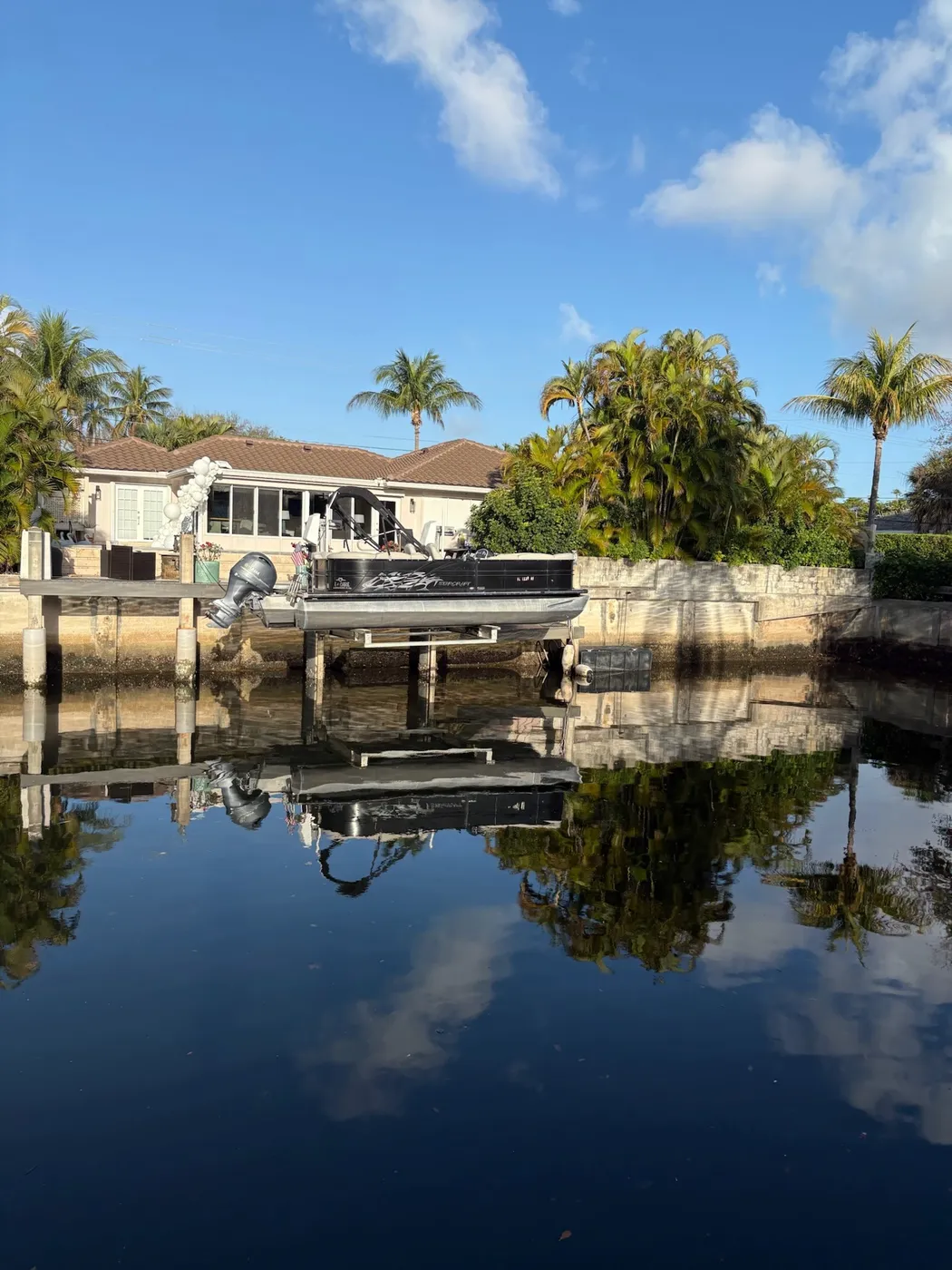 Calm residential canal at mean low water before dredging